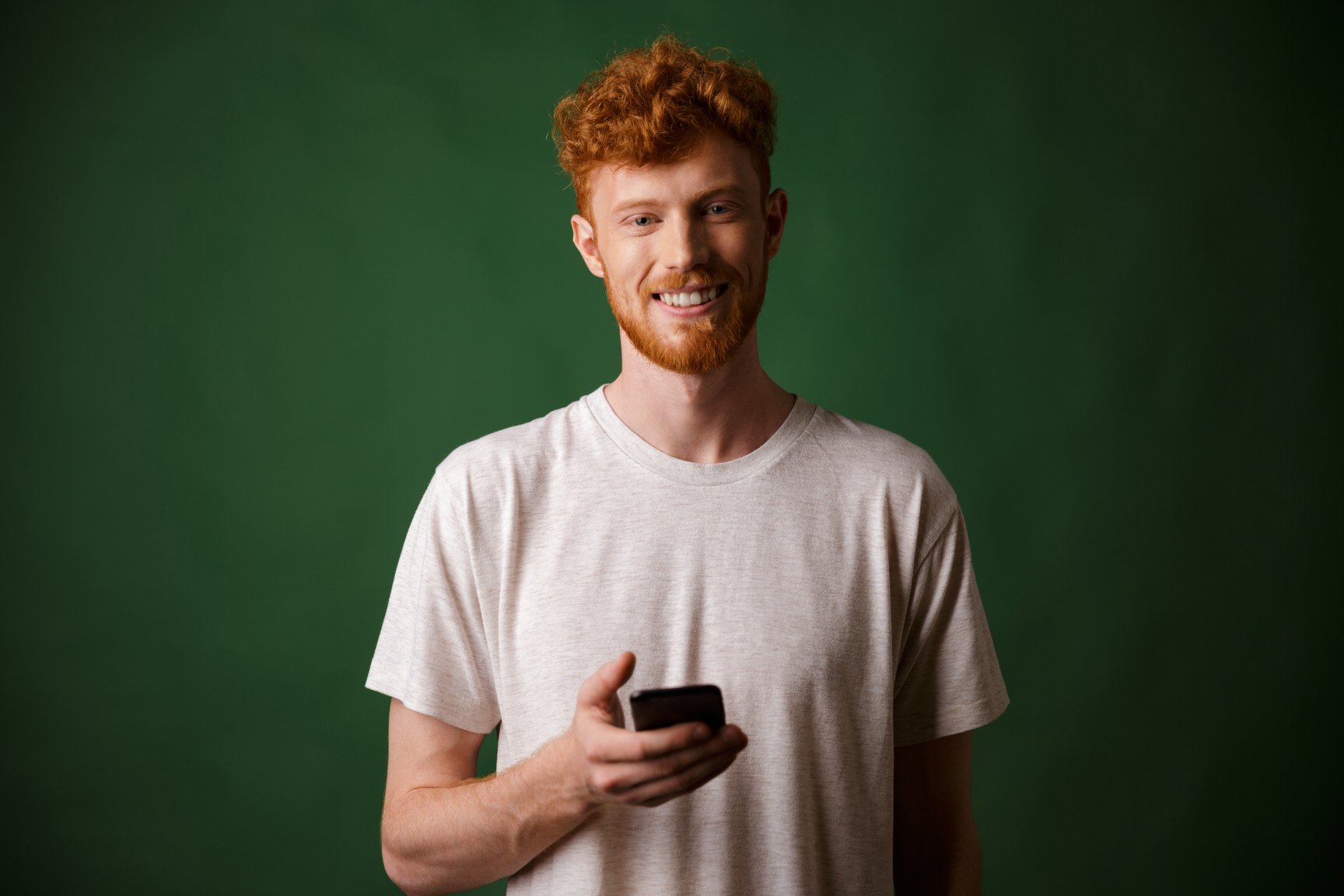 Portrait of Young Smiling Redhead Bearded Young Man